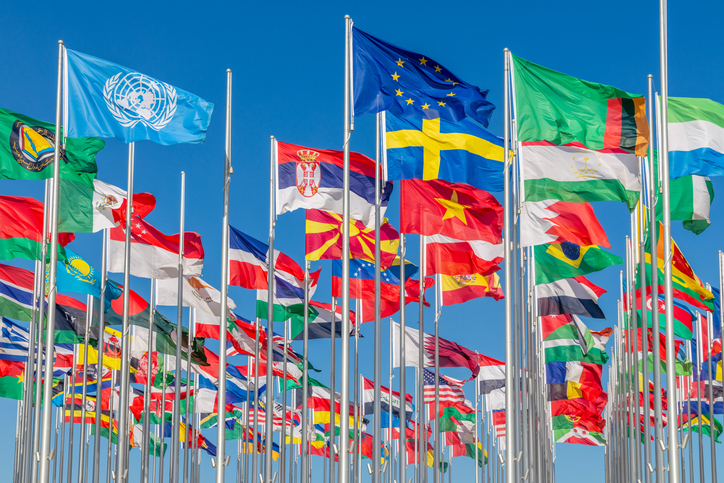 Many world's countries national flags waving on the wind, with United Nation, European Union, Sweden, Serbian, Vietnam, Zambian, Tajikistan, banners in the foreground, Doha, Qatar stock photo